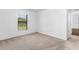 Simple bedroom with neutral colored carpet and window at 5952 Gillot Blvd, Port Charlotte, FL 33981