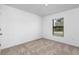 Bright bedroom featuring neutral wall paint and carpet flooring at 5952 Gillot Blvd, Port Charlotte, FL 33981