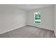 Spacious bedroom with grey carpeting and a large window at 5952 Gillot Blvd, Port Charlotte, FL 33981