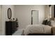 Cozy bedroom with a full bed, dresser, and a view of another room at 10439 Lavender Aster Trl, San Antonio, FL 33576