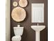 Stylish bathroom with pedestal sink and decorative wall art at 10439 Lavender Aster Trl, San Antonio, FL 33576