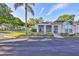 Exterior view of a villa with a screened porch and palm trees at 906 Golfview Woods Dr # 906, Ruskin, FL 33573