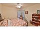 Cozy bedroom featuring a double bed, ceiling fan, and built-in shelving at 906 Golfview Woods Dr # 906, Ruskin, FL 33573