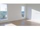 Bright bedroom has two large picture windows and light colored floors at 3850 Pompano Se Dr # 1, St Petersburg, FL 33705