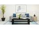Cozy living room featuring a gray sofa, coffee table, and stylish artwork at 32106 Powderpuff Mimosa Dr, San Antonio, FL 33576