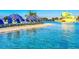 Stunning lagoon pool with sandy beach area and lounge chairs at 32106 Powderpuff Mimosa Dr, San Antonio, FL 33576