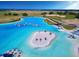 Aerial view of Crystal Lagoon with sandy beach and watersports at 32106 Powderpuff Mimosa Dr, San Antonio, FL 33576