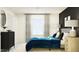 Well-lit bedroom featuring a blue comforter and modern decor at 32106 Powderpuff Mimosa Dr, San Antonio, FL 33576