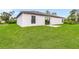Spacious backyard with grassy lawn and patio at 6007 Gillot Blvd, Port Charlotte, FL 33981