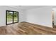 Bedroom with wood-look flooring and sliding glass doors leading to a patio at 6007 Gillot Blvd, Port Charlotte, FL 33981