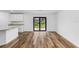 Living area with wood-look floors and access to a patio at 6007 Gillot Blvd, Port Charlotte, FL 33981