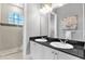 Modern bathroom with double sinks, granite countertops, and walk-in shower at 5016 Givendale Ln, Tampa, FL 33647