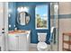 Stylish bathroom with vanity, toilet, walk-in shower, and natural light from the window at 5016 Givendale Ln, Tampa, FL 33647