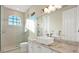 Bright bathroom featuring marble countertops, modern fixtures, and a glass-enclosed shower at 5016 Givendale Ln, Tampa, FL 33647