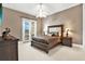 Comfortable bedroom featuring a tufted headboard, soft lighting, and a private exterior door at 5016 Givendale Ln, Tampa, FL 33647