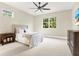 Bright bedroom features a large window with verdant views and a neutral color scheme at 5016 Givendale Ln, Tampa, FL 33647