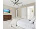 Cozy bedroom featuring a ceiling fan, TV, and ensuite bathroom at 5016 Givendale Ln, Tampa, FL 33647