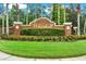 Attractive brick entrance to the Whitehall community, featuring manicured landscaping and a stately sign at 5016 Givendale Ln, Tampa, FL 33647