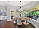 Dining room featuring dark wood floors and views of the pool and lanai at 5016 Givendale Ln, Tampa, FL 33647
