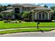 A luxurious home with a well-kept lawn and manicured landscaping, complemented by an old-fashioned mailbox at 5016 Givendale Ln, Tampa, FL 33647