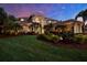 Beautiful two-story home featuring manicured lawn and professional landscaping at 5016 Givendale Ln, Tampa, FL 33647