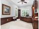 Elegant home office features custom wood built-ins, large windows, and a comfortable workspace at 5016 Givendale Ln, Tampa, FL 33647