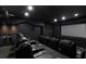 Black home theater with reclining leather seating, projector, and wet bar at 5016 Givendale Ln, Tampa, FL 33647