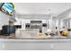 Modern kitchen featuring a granite island, stainless steel appliances, and custom cabinetry at 5016 Givendale Ln, Tampa, FL 33647