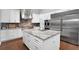 Chef's kitchen with a large island, stainless steel appliances, and custom cabinetry for storage at 5016 Givendale Ln, Tampa, FL 33647