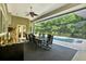 Covered lanai with outdoor dining area overlooking a sparkling screened pool at 5016 Givendale Ln, Tampa, FL 33647