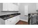 Well-organized laundry room featuring modern machines and ample storage with granite countertops at 5016 Givendale Ln, Tampa, FL 33647
