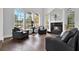 Bright living room boasts fireplace, hardwood floors, arch windows and comfortable seating at 5016 Givendale Ln, Tampa, FL 33647