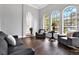 Bright living room features large windows and comfortable seating, creating a welcoming and airy space at 5016 Givendale Ln, Tampa, FL 33647