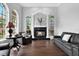 Cozy living room with a fireplace framed by pillars and arch, flanked by arched windows at 5016 Givendale Ln, Tampa, FL 33647