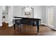 Elegant living room featuring a grand piano, hardwood floors, and a chandelier at 5016 Givendale Ln, Tampa, FL 33647