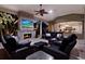 Outdoor living area featuring a fireplace, TV, ceiling fan and a view of the dining area at 5016 Givendale Ln, Tampa, FL 33647
