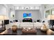 Spacious living room with white couches, hardwood floors, recessed lighting, and display shelving at 5016 Givendale Ln, Tampa, FL 33647