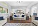 Comfortable living room featuring hardwood floors, white sofas, and designer accent pieces at 5016 Givendale Ln, Tampa, FL 33647