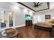 A serene main bedroom with hardwood floors, dresser, ceiling fan, and outdoor patio access at 5016 Givendale Ln, Tampa, FL 33647