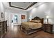 Elegant main bedroom with dark wood furniture, hardwood flooring and adjacent bath at 5016 Givendale Ln, Tampa, FL 33647