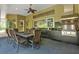 Inviting covered outdoor dining area with a full kitchen, granite counters and comfortable seating at 5016 Givendale Ln, Tampa, FL 33647