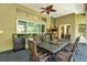 Covered lanai featuring outdoor kitchen and dining area at 5016 Givendale Ln, Tampa, FL 33647
