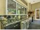 Outdoor kitchen with granite countertops, cabinetry, dishwasher and stainless steel accents at 5016 Givendale Ln, Tampa, FL 33647