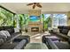 Inviting outdoor patio featuring comfortable seating, a fireplace, and lush tropical garden views at 5016 Givendale Ln, Tampa, FL 33647