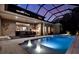 Stunning screened-in pool with integrated spa, outdoor kitchen, and lush landscaping at 5016 Givendale Ln, Tampa, FL 33647