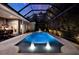 Inviting screened-in pool with water features, outdoor kitchen, and beautiful surroundings at 5016 Givendale Ln, Tampa, FL 33647