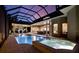 Luxurious screened-in pool and spa area with an outdoor living space and bar at 5016 Givendale Ln, Tampa, FL 33647