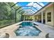 A luxurious swimming pool and hot tub surrounded by a screened enclosure at 5016 Givendale Ln, Tampa, FL 33647