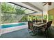 A luxurious screened-in pool area with a fountain feature for enhanced relaxation and enjoyment at 5016 Givendale Ln, Tampa, FL 33647