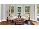 Bright sitting area with comfortable chairs and large windows overlooking the pool at 5016 Givendale Ln, Tampa, FL 33647